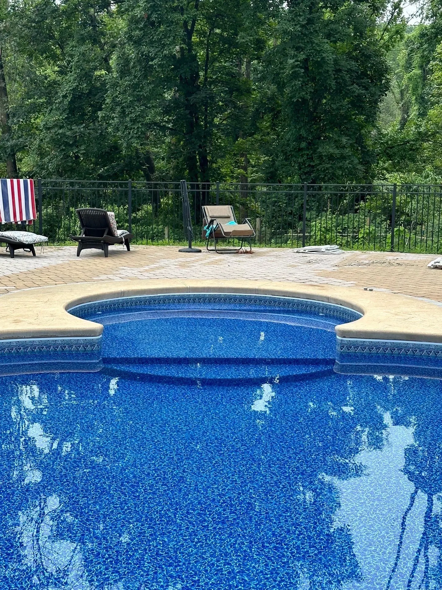 A pool with an empty swimming pool in the background.