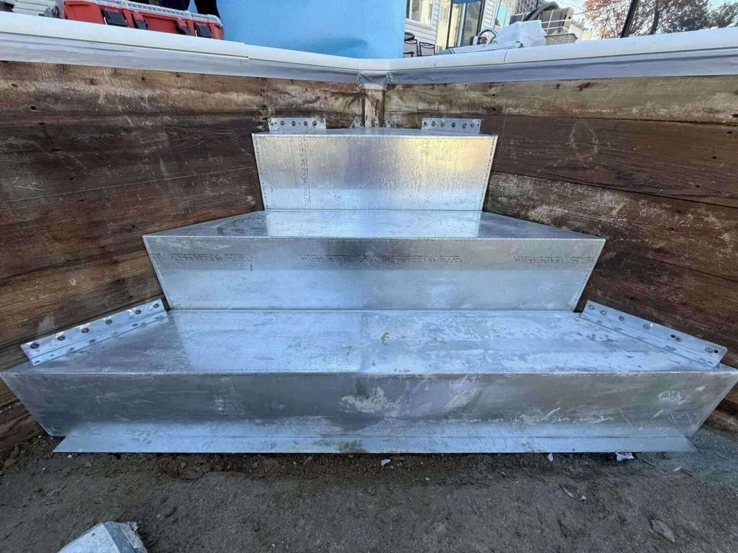 A metal staircase with steps going up to the top.