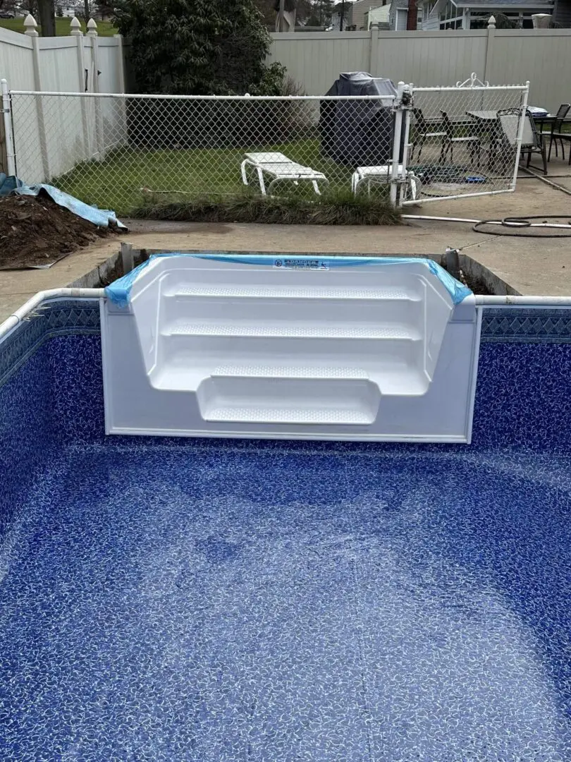 A pool with steps in the middle of it