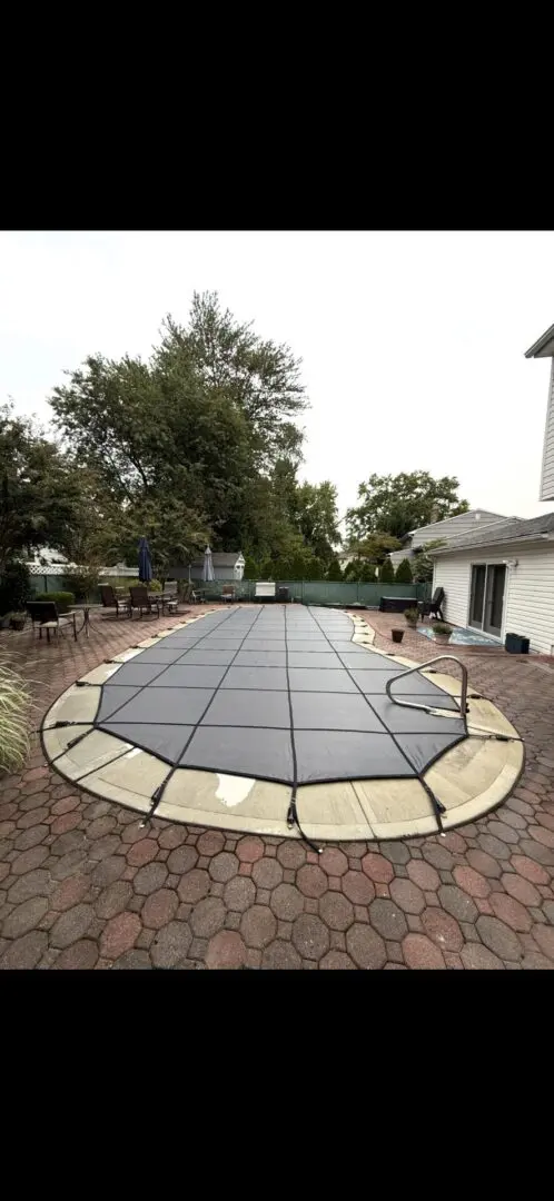 Pool cover on a patterned brick patio