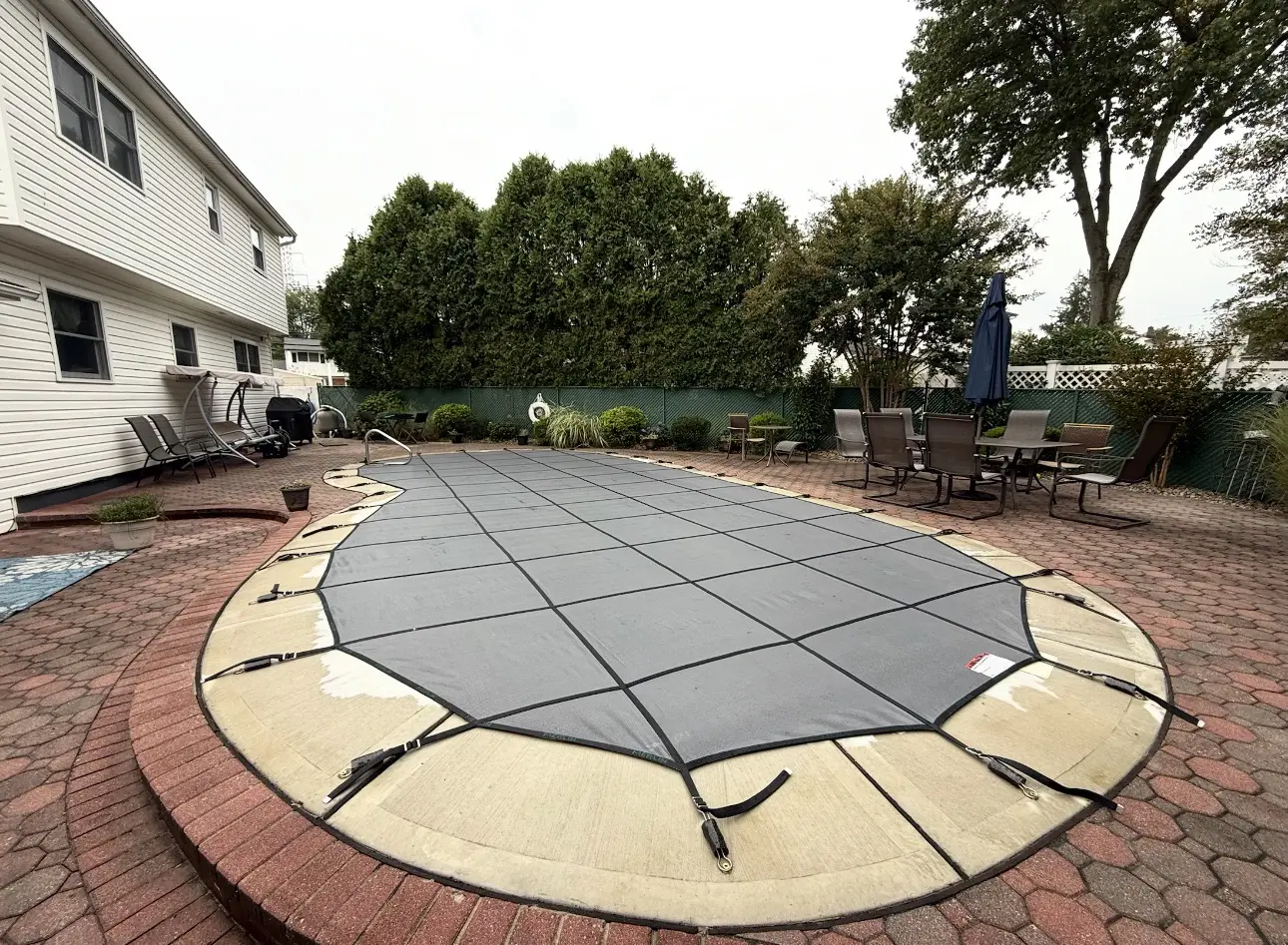 Rectangular pool cover with seating nearby