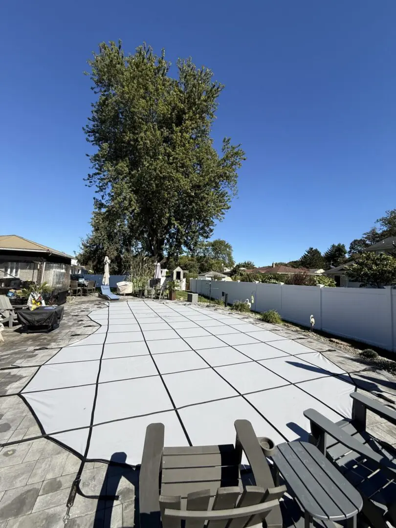 "Expansive pool cover under clear blue sky"