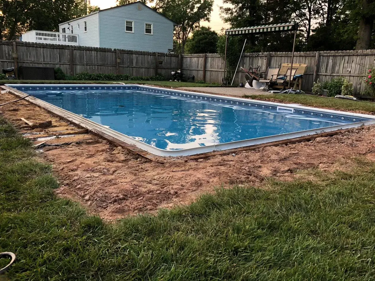 A pool that is in the middle of some grass.