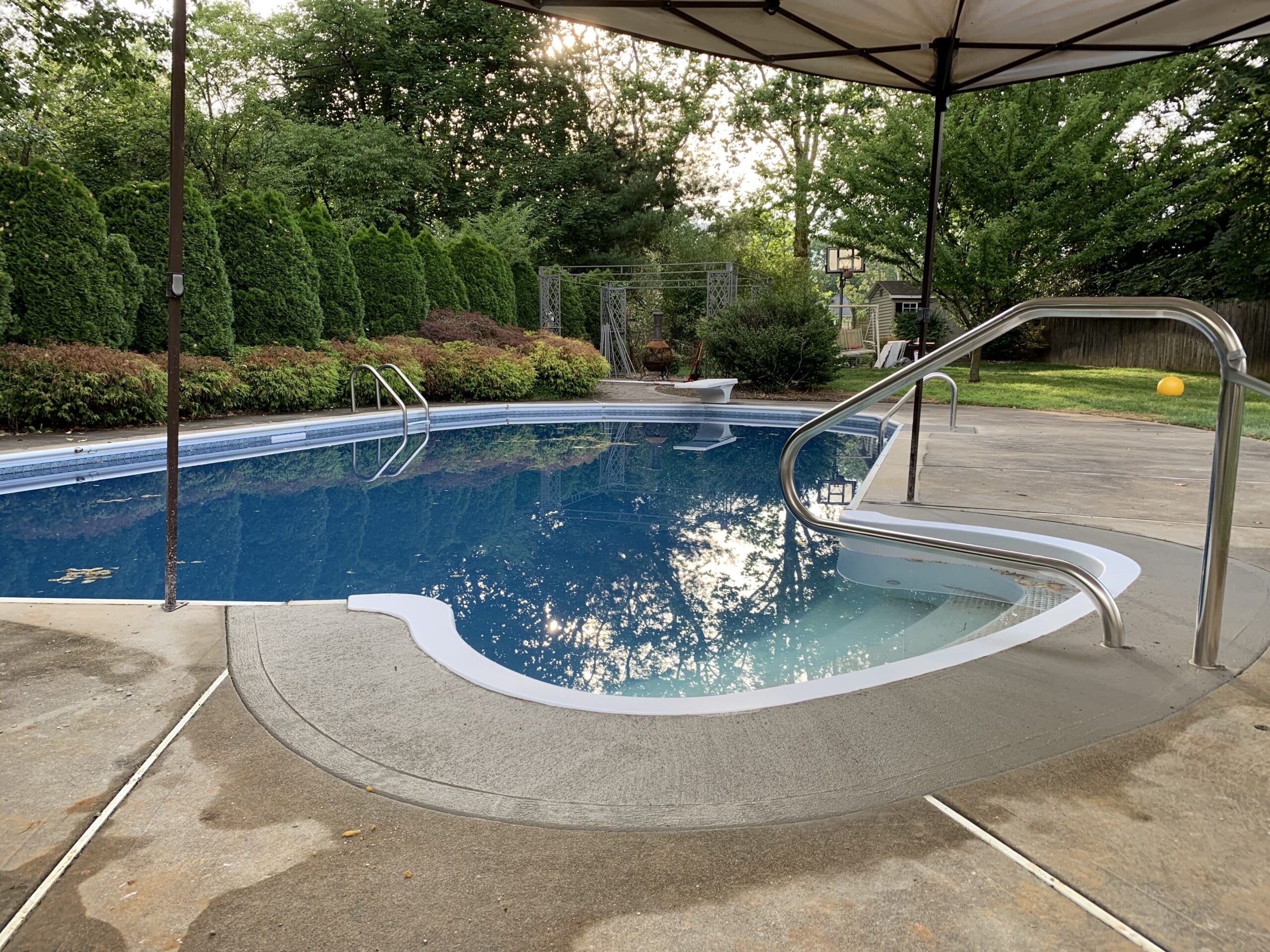 A pool with water falling into it.